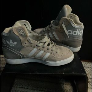 Gray adidas hightops.